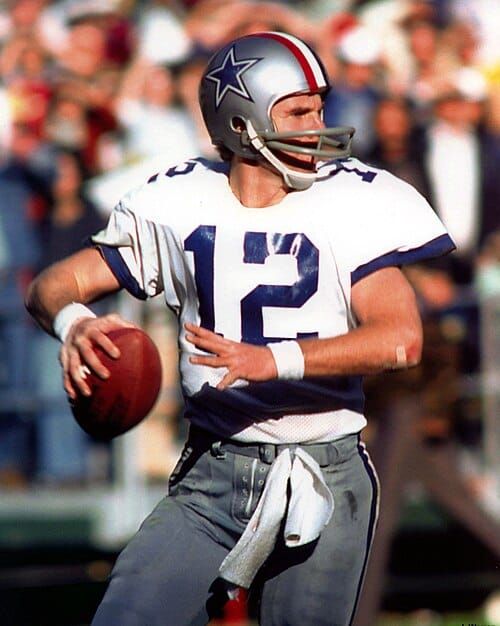 Photo of a football quarterback about to throw a pass