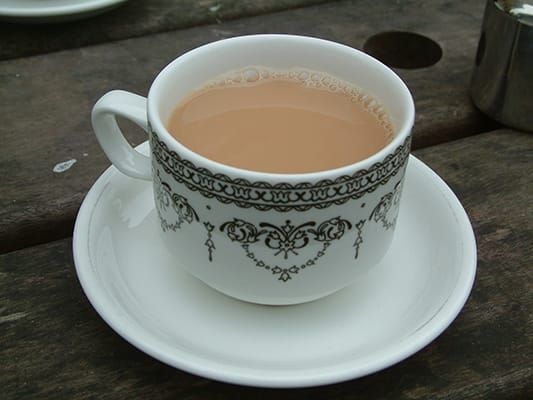 Photo of a cup of black tea with milk