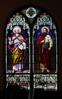 Photo of a stained-glass window depicting the apostles Peter & Paul