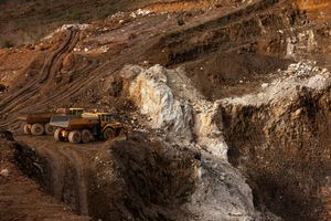 Mining trucks at an open-pit mine site, representing Omnia  mining operation