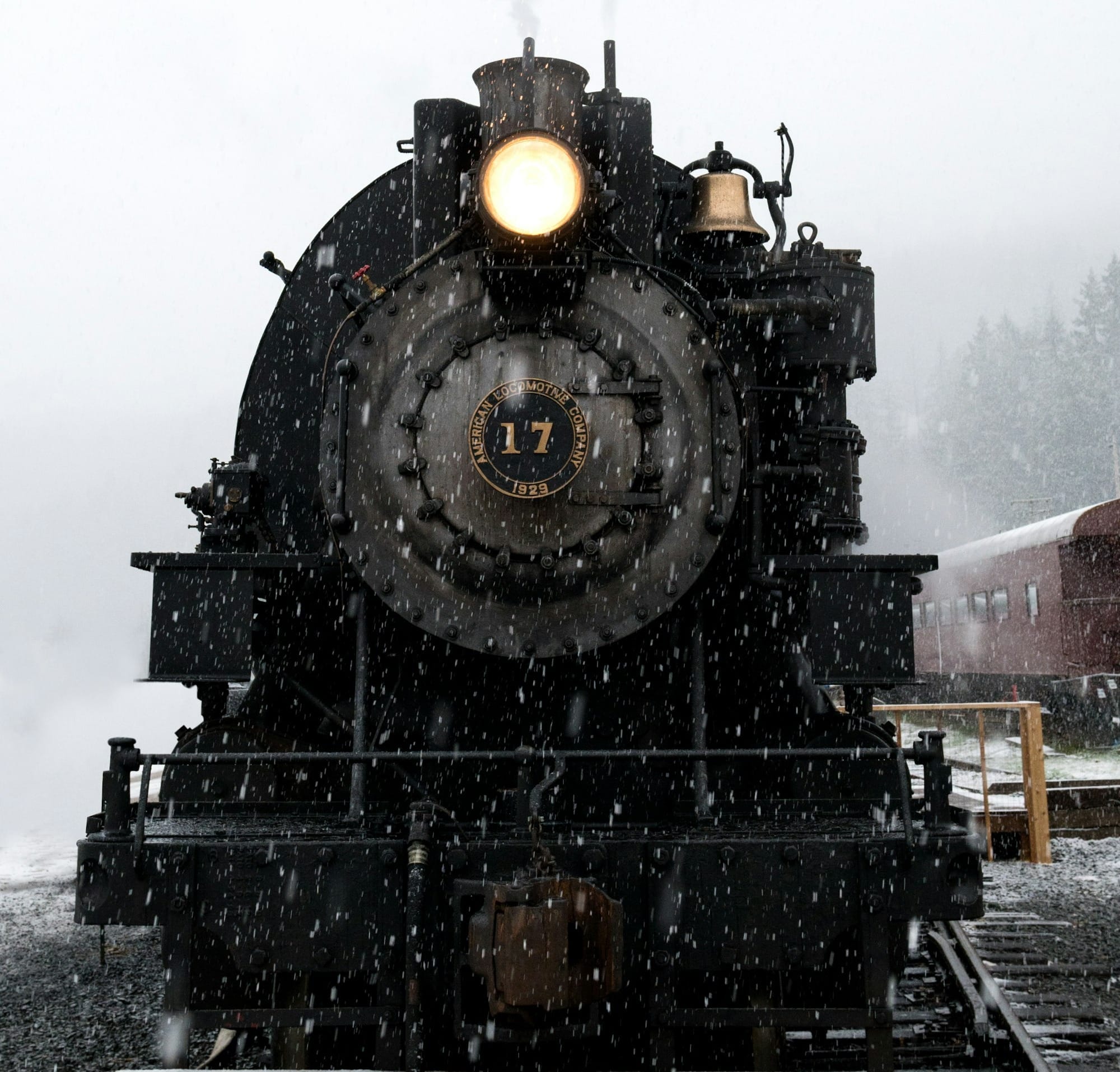 black train on railway at daytime