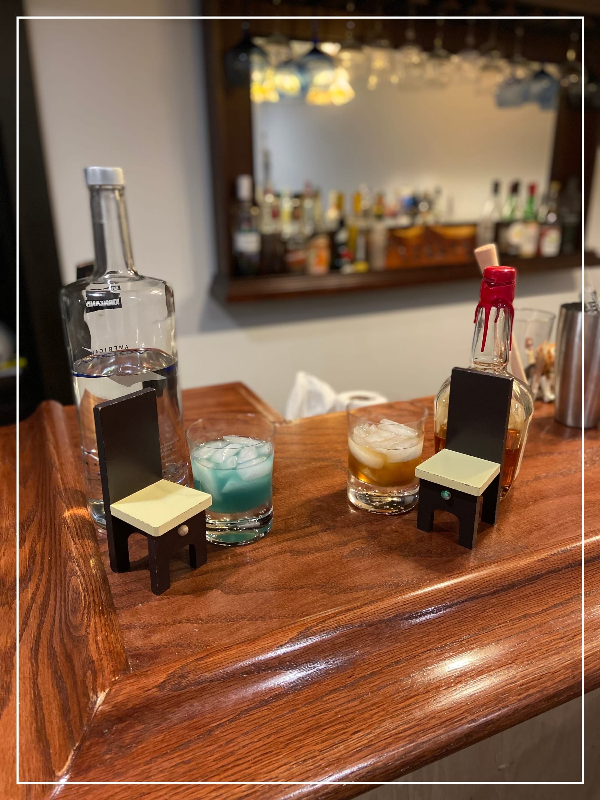 Two cocktails next to small chairs