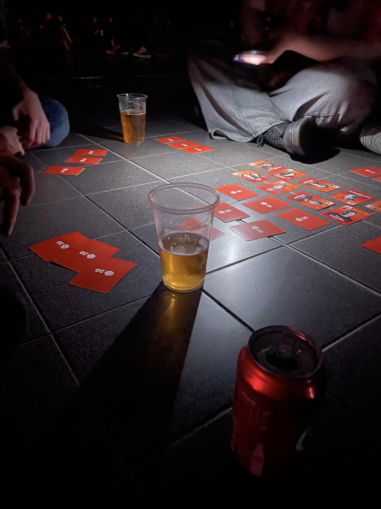 Fans play a drinking game with GBB playing cards during a judge showcase.