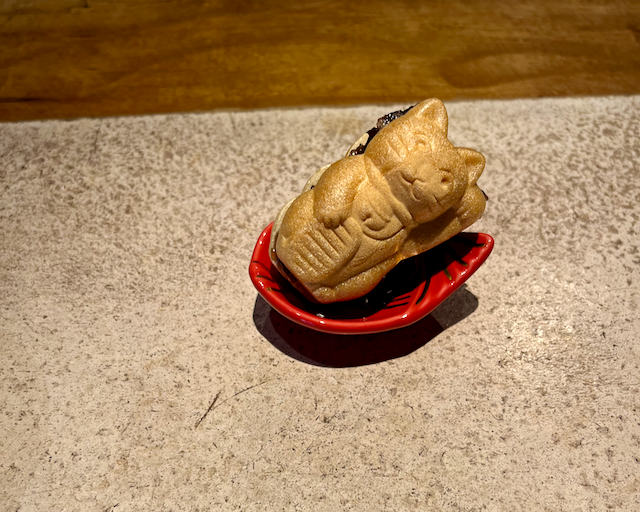 A manekineko shaped rice wafle filled with chunky anko bean paste