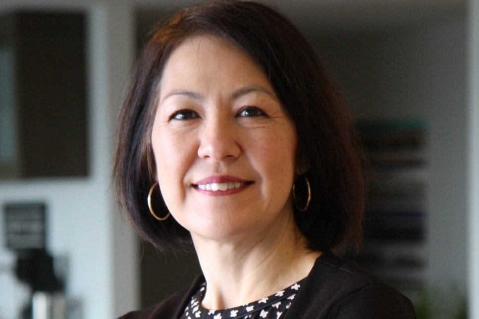 A portrait of Leesa Manion, smiling to the camera.