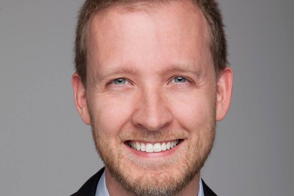 A close-up portrait of Jeff Manson, smiling towards the camera.