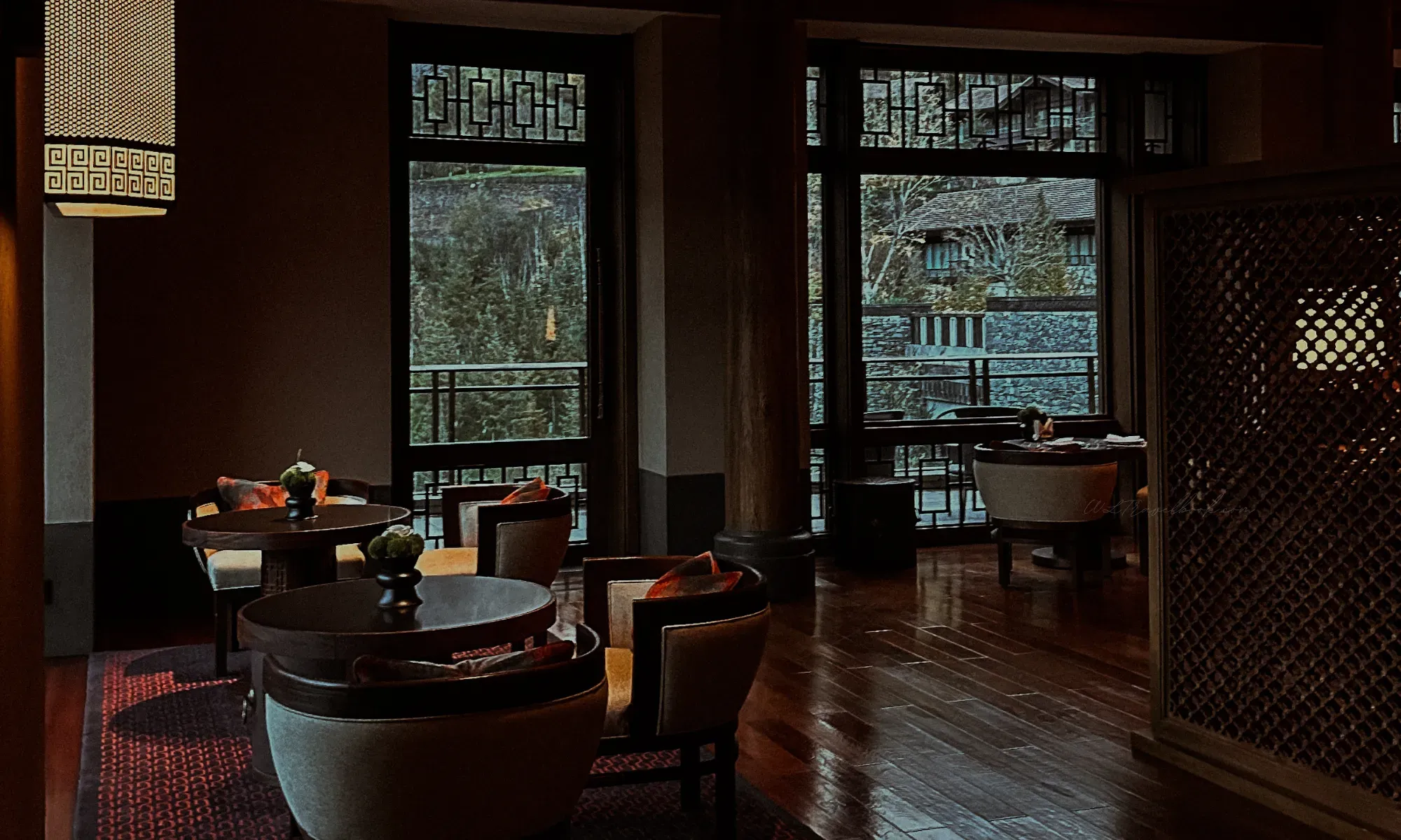 Rissai Valley interior lounge with traditional dark wood architecture and Tibetan cultural design elements, by WLTravelbook