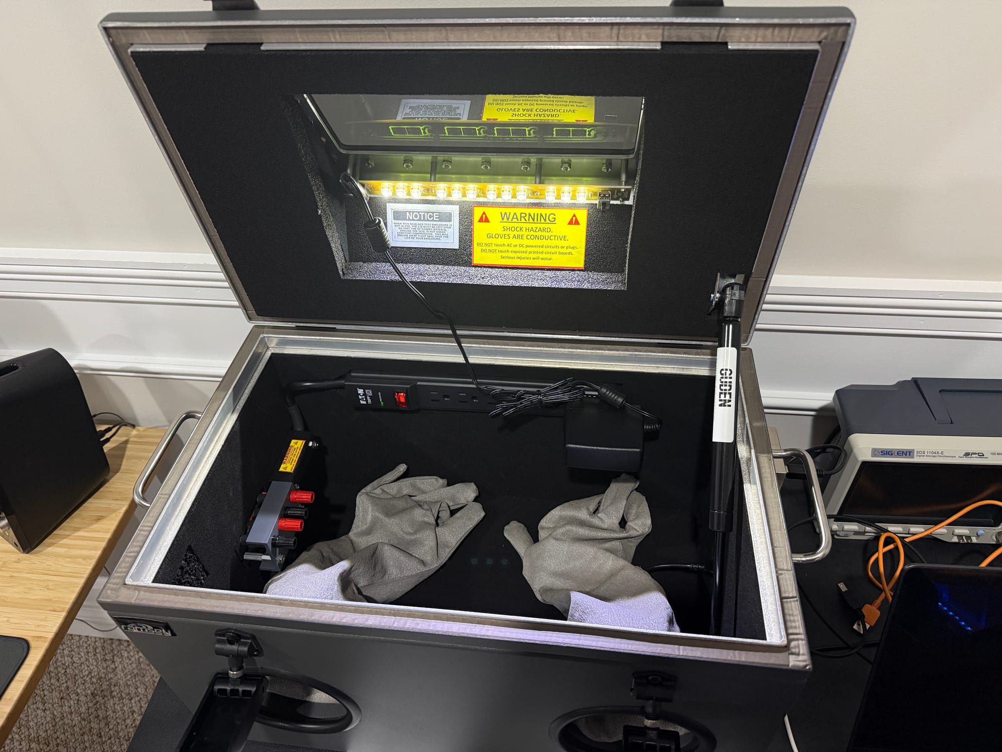 Interior of the Ramsey STE3000M with door open showing absorber foam, gloves, and warning labels