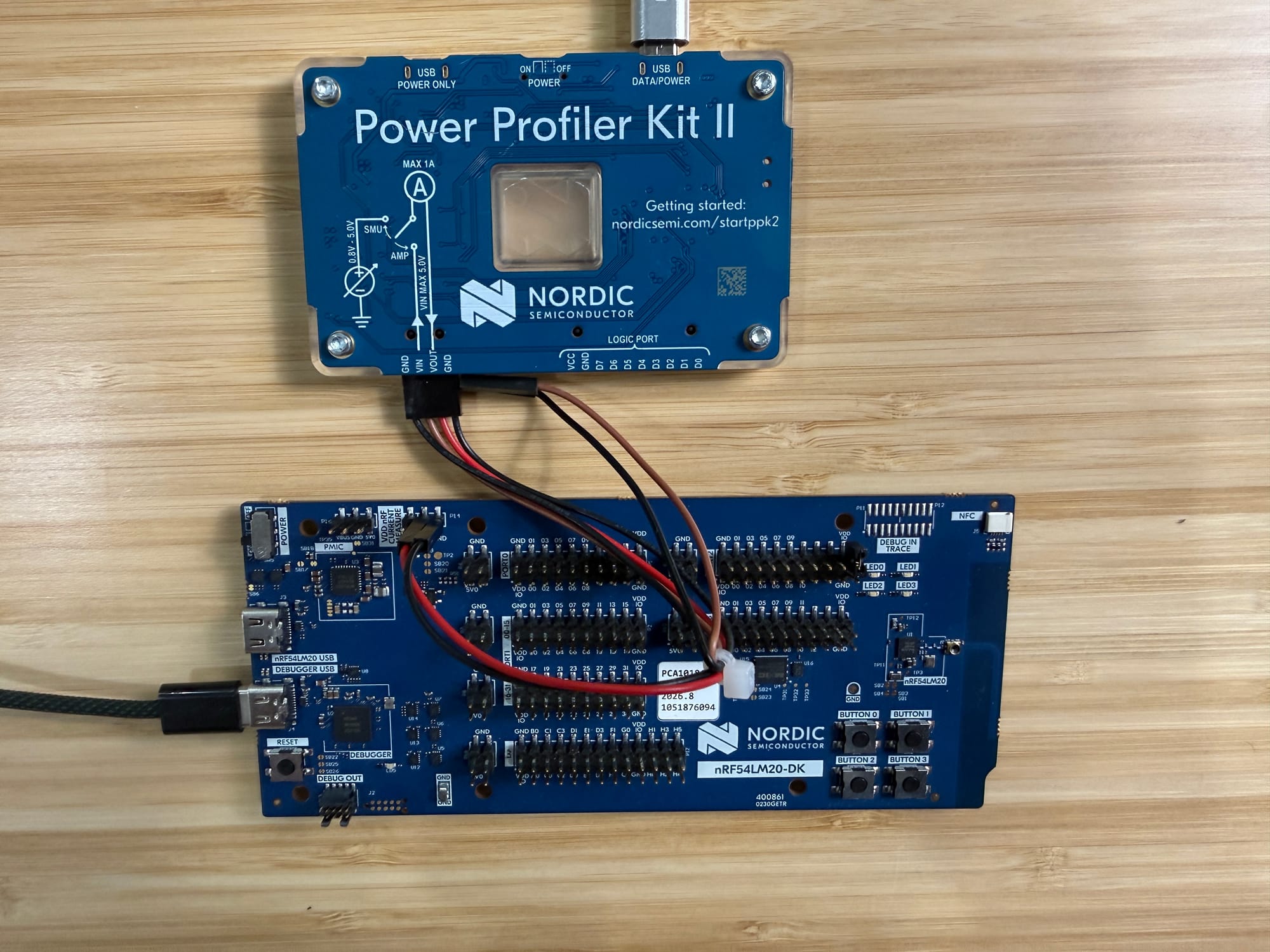 Nordic Power Profiler Kit II wired to the nRF54LM20 DK via the P14 4-pin jumper harness. USB-C plugged into the DK's J-Link port.