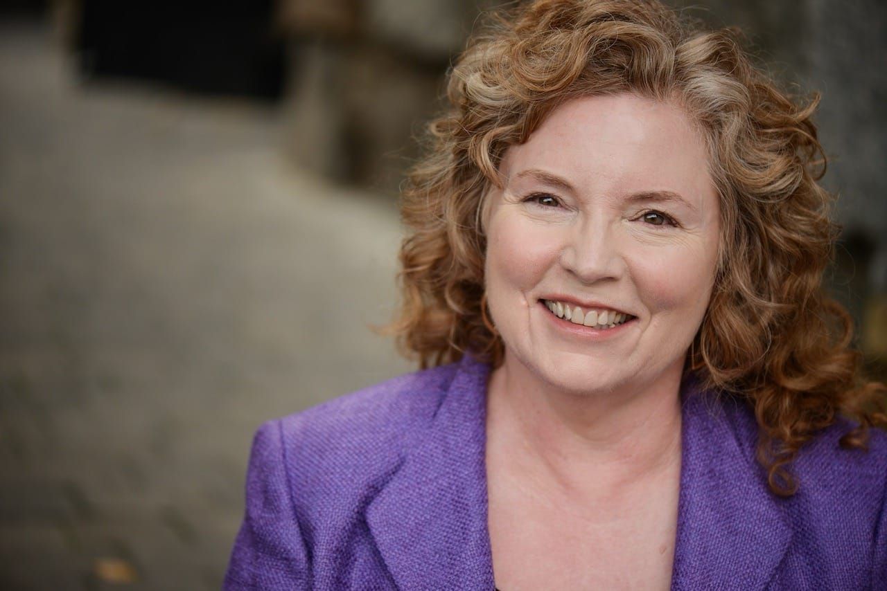 Susan Rotman in purple blazer smiling