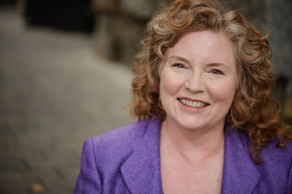 Susan Rotman in purple blazer smiling