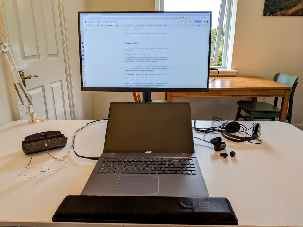 Photo of a home desk with a laptop connected to a monitor.