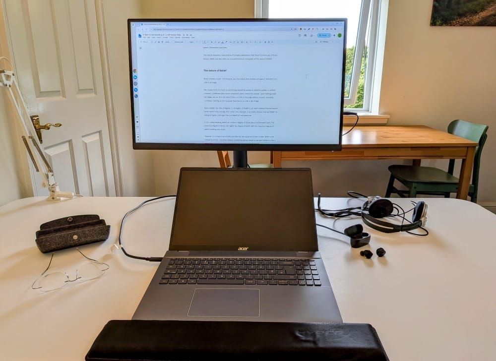 Photo of a home desk with a laptop connected to a monitor.
