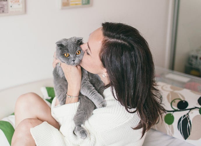 Girl with a cat on a bed
