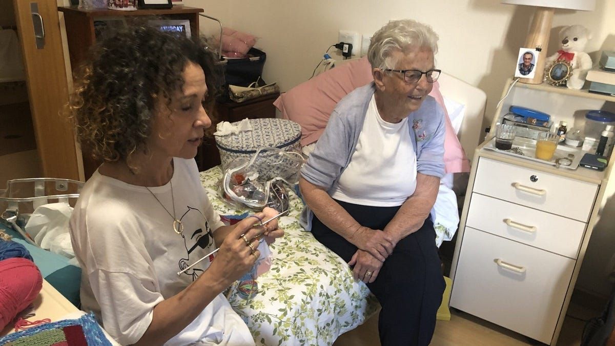 Nursing home resident knits for those in need