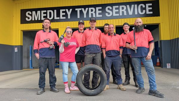 Krystal Hatswell and her colleagues from Smedley Tyre Service wear pink for a National Breast Cancer Foundation fundraiser.