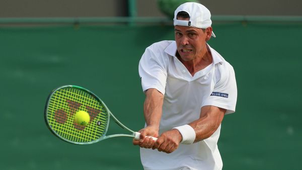 Alex Bolt hits a forehand tennis shot.