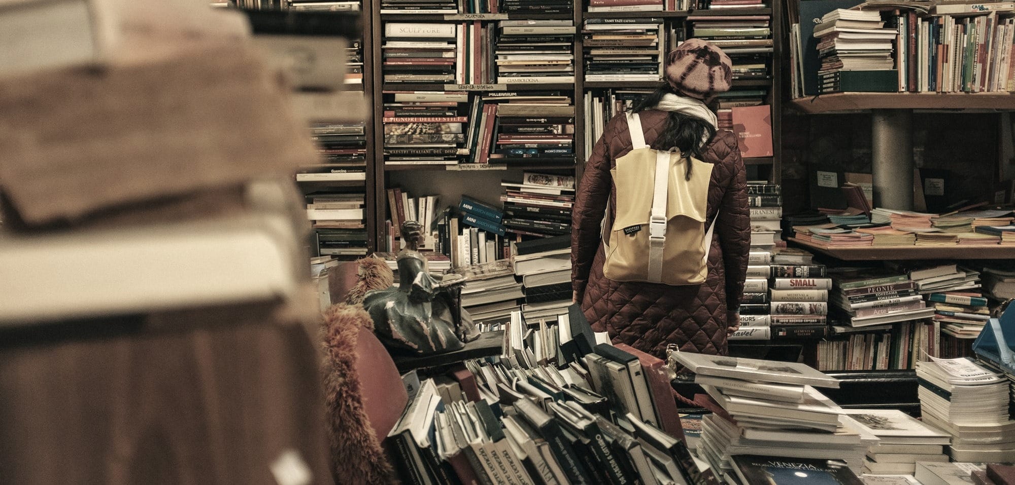 person carrying backpack inside library