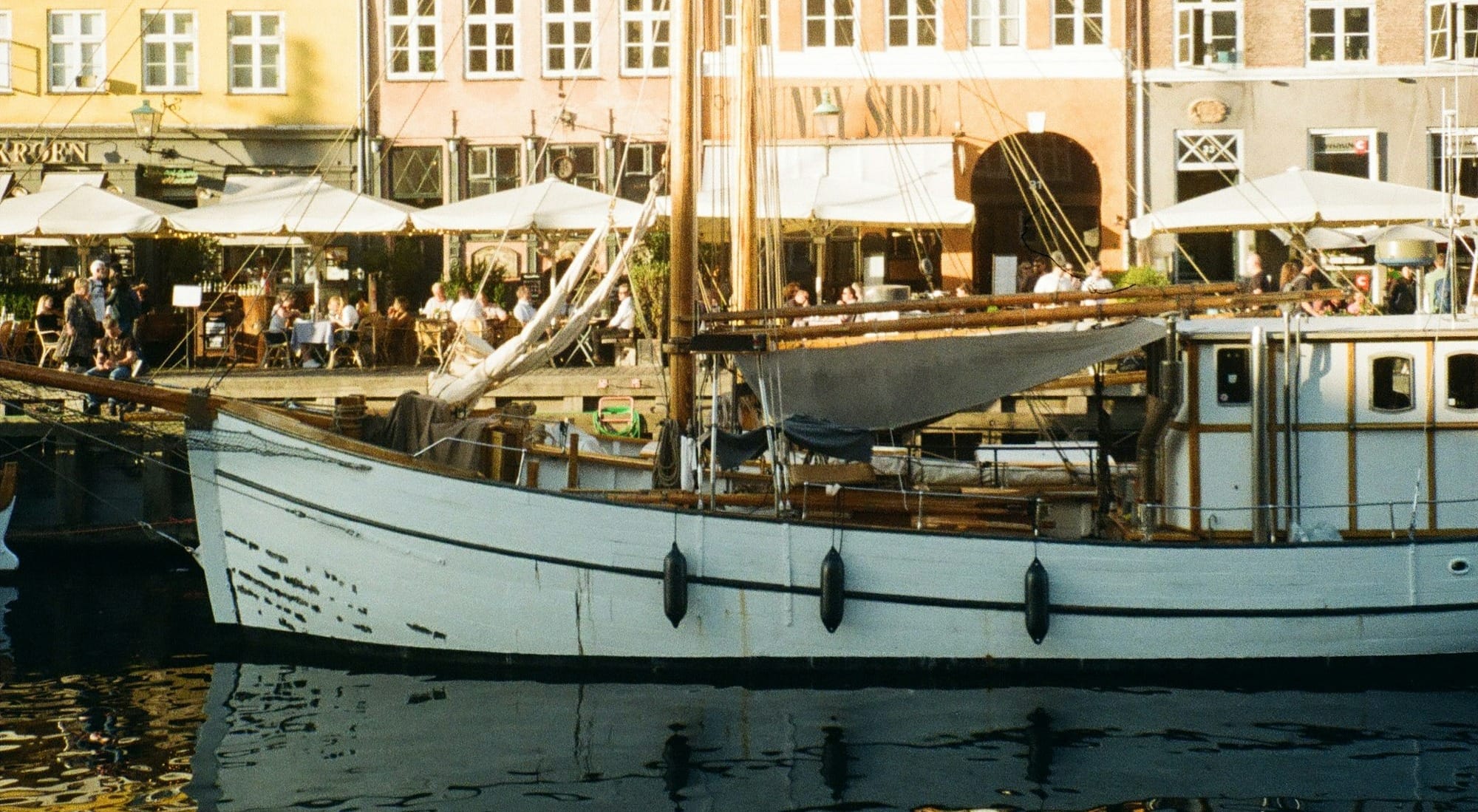 a white boat floating on top of a body of water