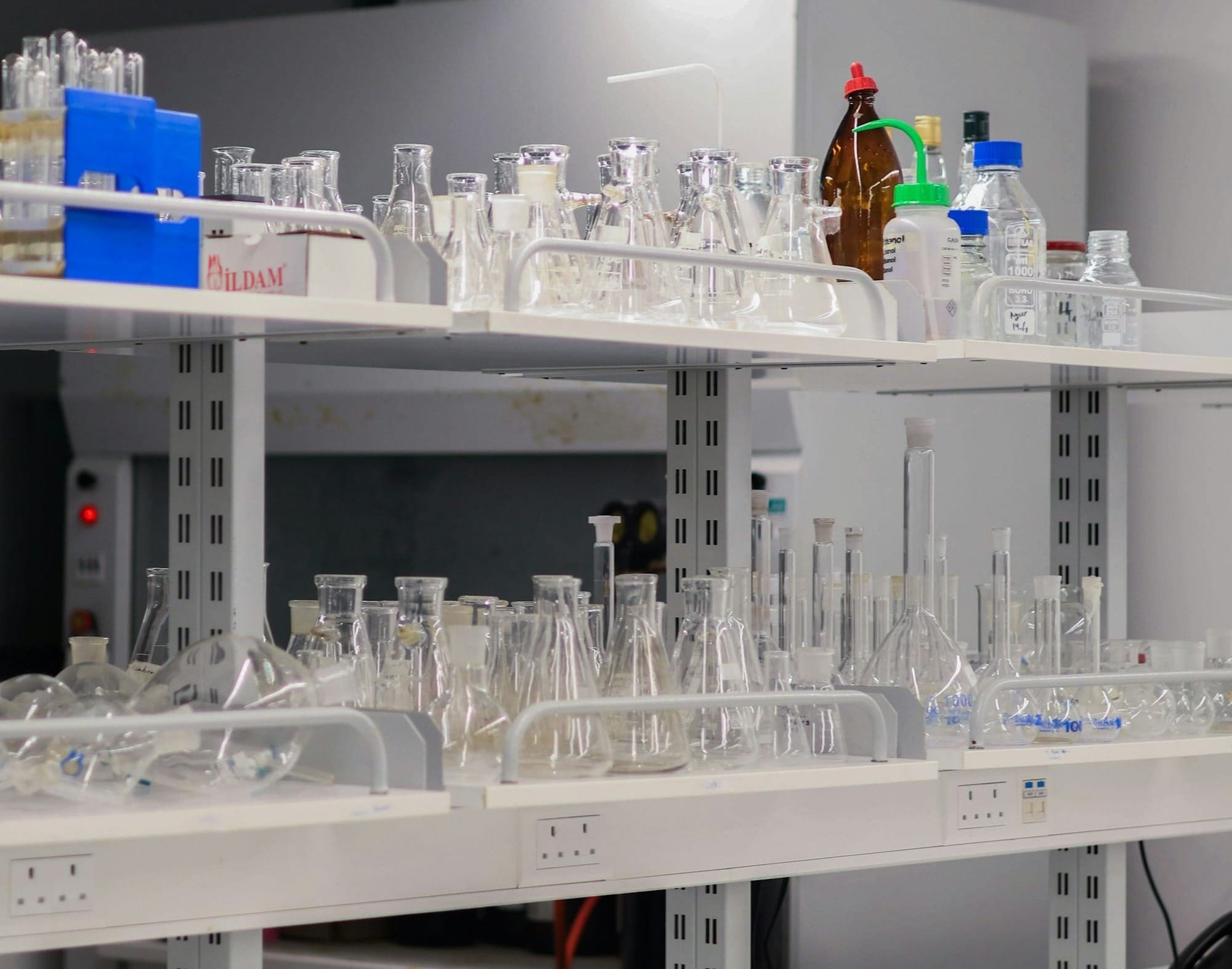 Laboratory shelves filled with glassware and equipment