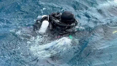 A diver from Finland takes part in a recovery operation for four missing Italian scuba divers who died in an accident in underwater caves near Vaavu Atoll, Maldives