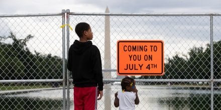Children look through fencing at the Washington Monument and Lincoln Memorial reflecting pool, in Washington, D.C., U.S., on June 27, 2026.
