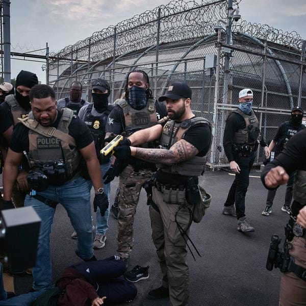A federal agent threatens to Taser protesters during a protest in Newark, NJ.