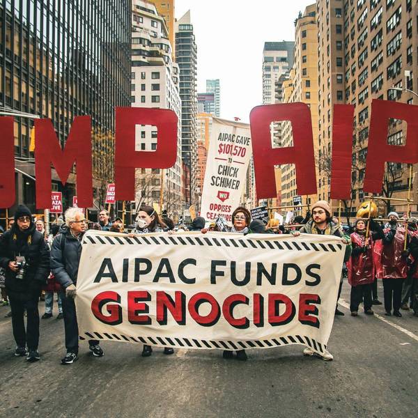 protesters hold a sign reading "AIPAC Funds Genocide" during a protest march