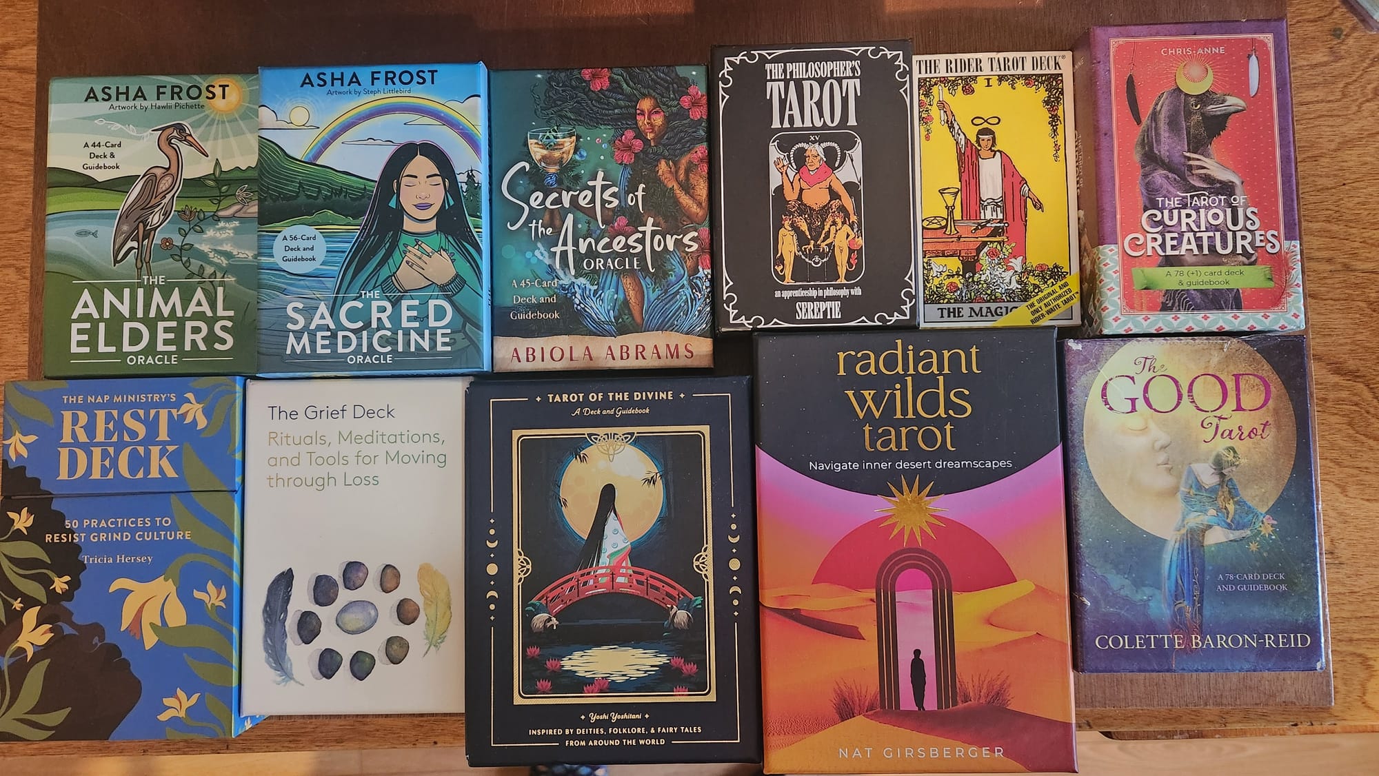 display of decks. Rest Deck by Tricia Hersey and Grief Deck, collective effort led by Adrienne Jenik. are cards to provoke discussion. Oracle decks: Animal Elders and the Sacred Medicine by Asha Frost, Secrets of the Ancestors by Abiola Abrams. Tarot Decks: The Philospher's Tarot by Sereptie, the traditional Rider Waite deck, Curious Creatures by Chris Anne, Tarot of the Divine by Yoshi Yoshitani, Radiant Wilds Tarot by Nat Girsberer and The Good Tarot by Colette Baron-Reid. 