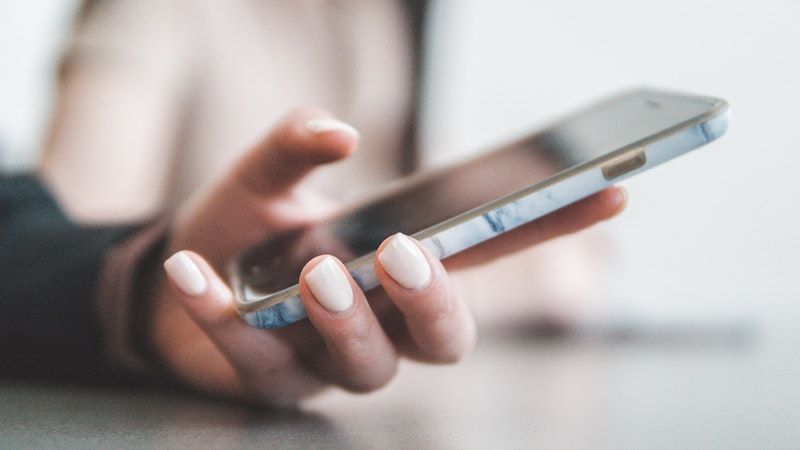 A hand holding a smartphone