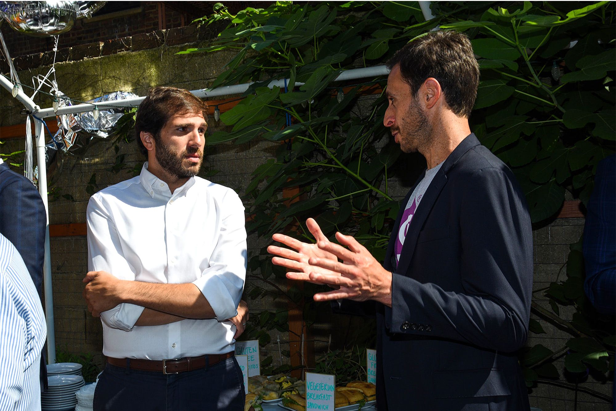 Getaround Policy Manager Luke Entelis (right) speaks with New York State Senator Andrew Gounardes.