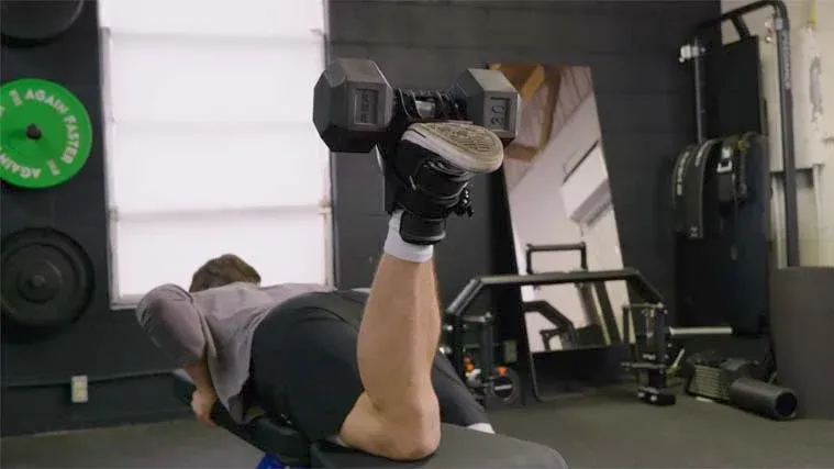 A person attaching a dumbbell to Monkey Feet