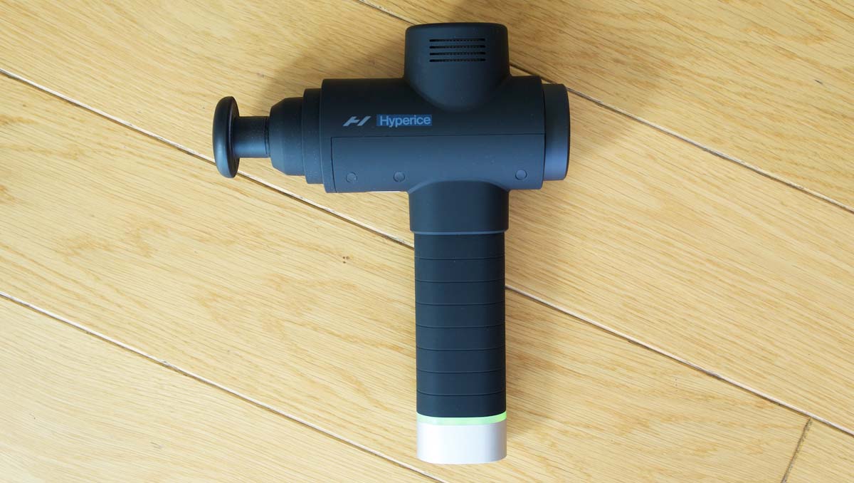 A massage gun with four massage heads and adjustable head angle