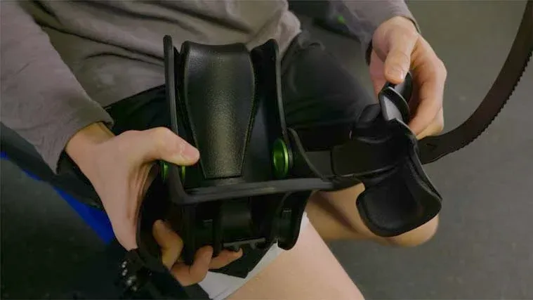 A person doing leg extensions on a Monkey Feet machine