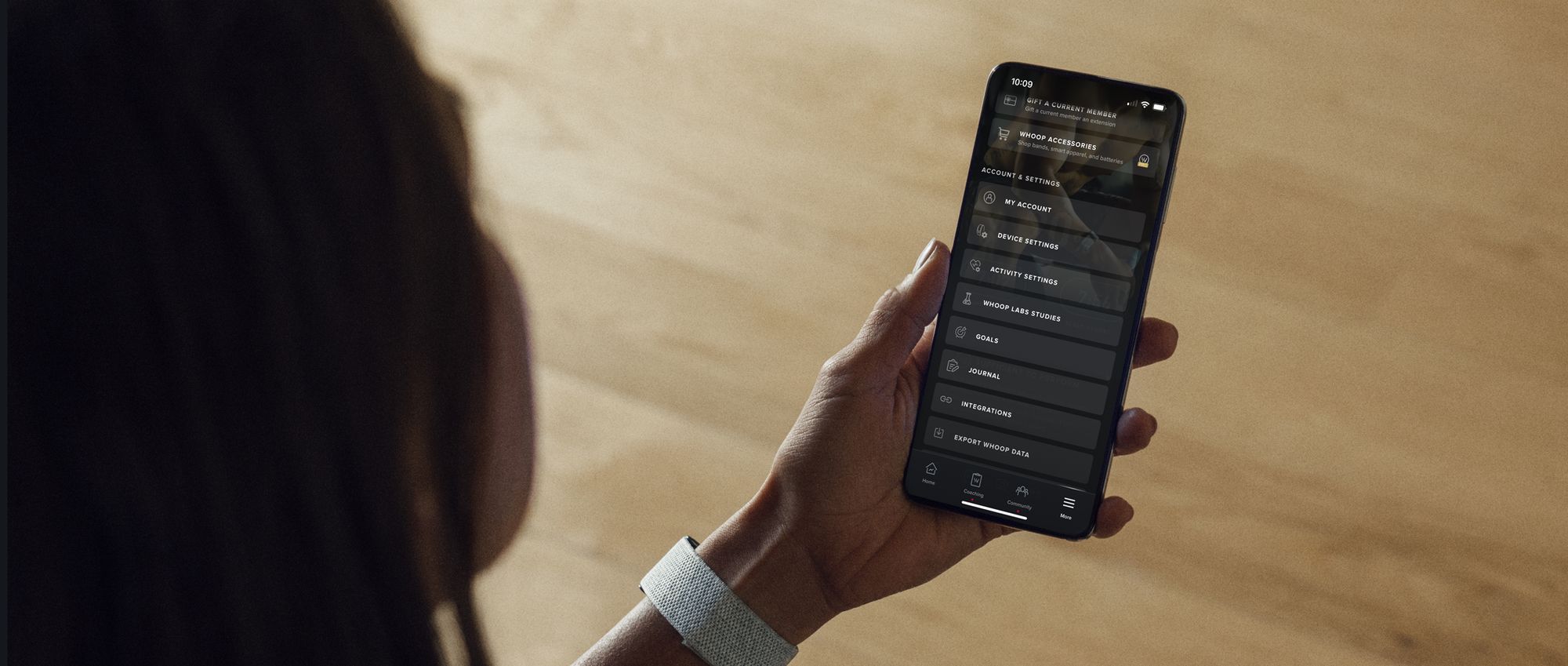 A person using a Whoop band at home