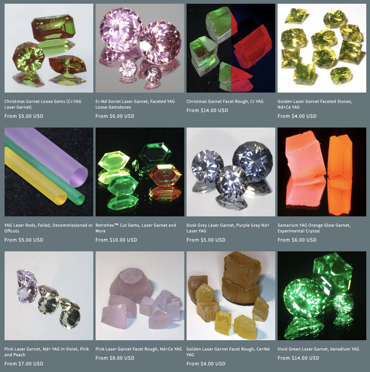 Screenshot of the Gems of Science Nd:YAG gems collection which is where they have a bunch of their laser gems. The uncut blanks look like some kind of gummy candy or Turkish Delight, and the cut gems are greens (Vanadium YAG), pinks (leftover Soviet Erbium YAG), golds (Nd + Ce YAG), and icy blue-greys (Nd:YAG). There are also some spectacular Cr:YAGs that are bright green with strong red fluorescence.