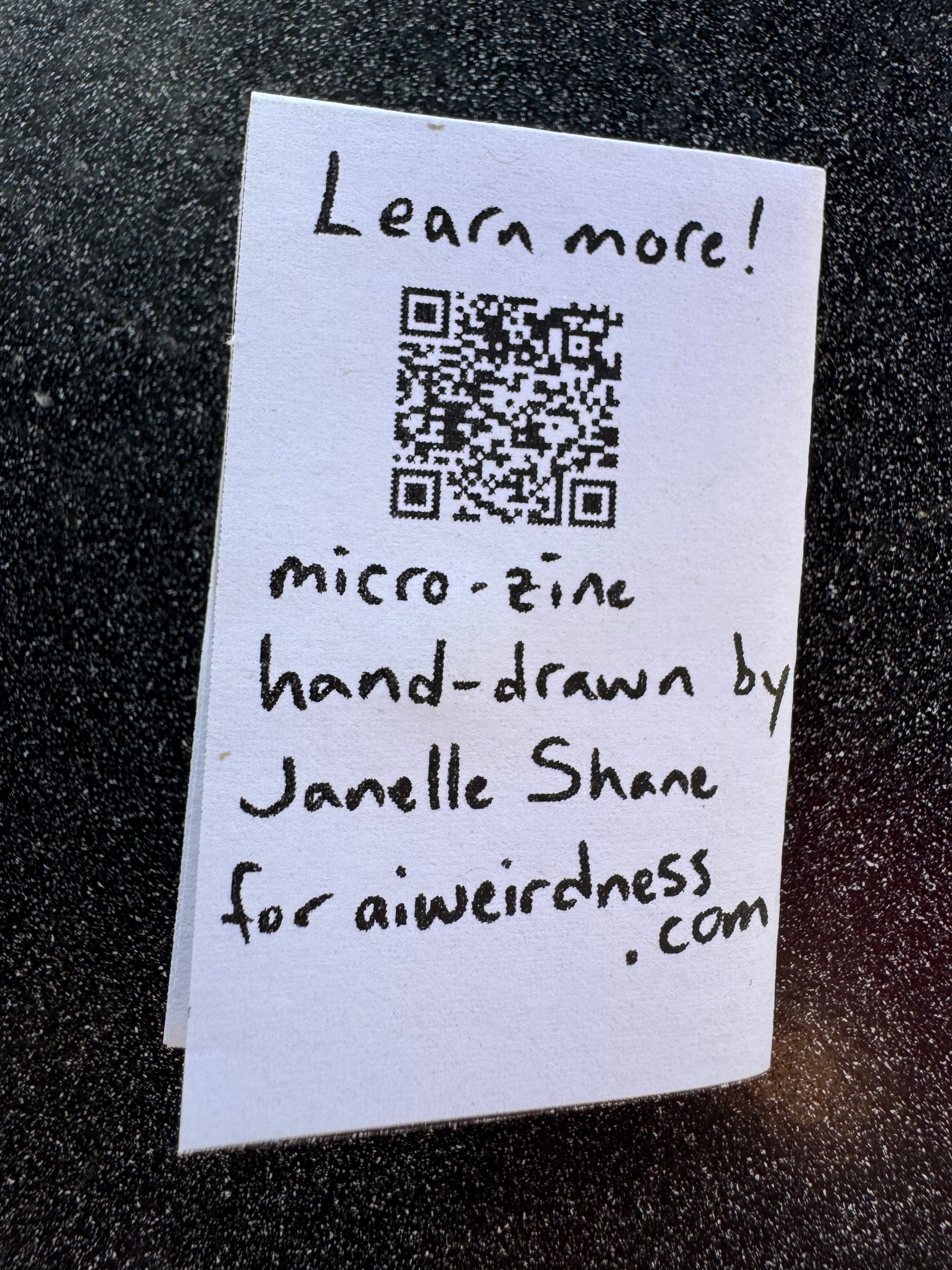 Learn more! (QR code) Micro-zine hand-drawn by Janelle Shane for aiweirdness.com