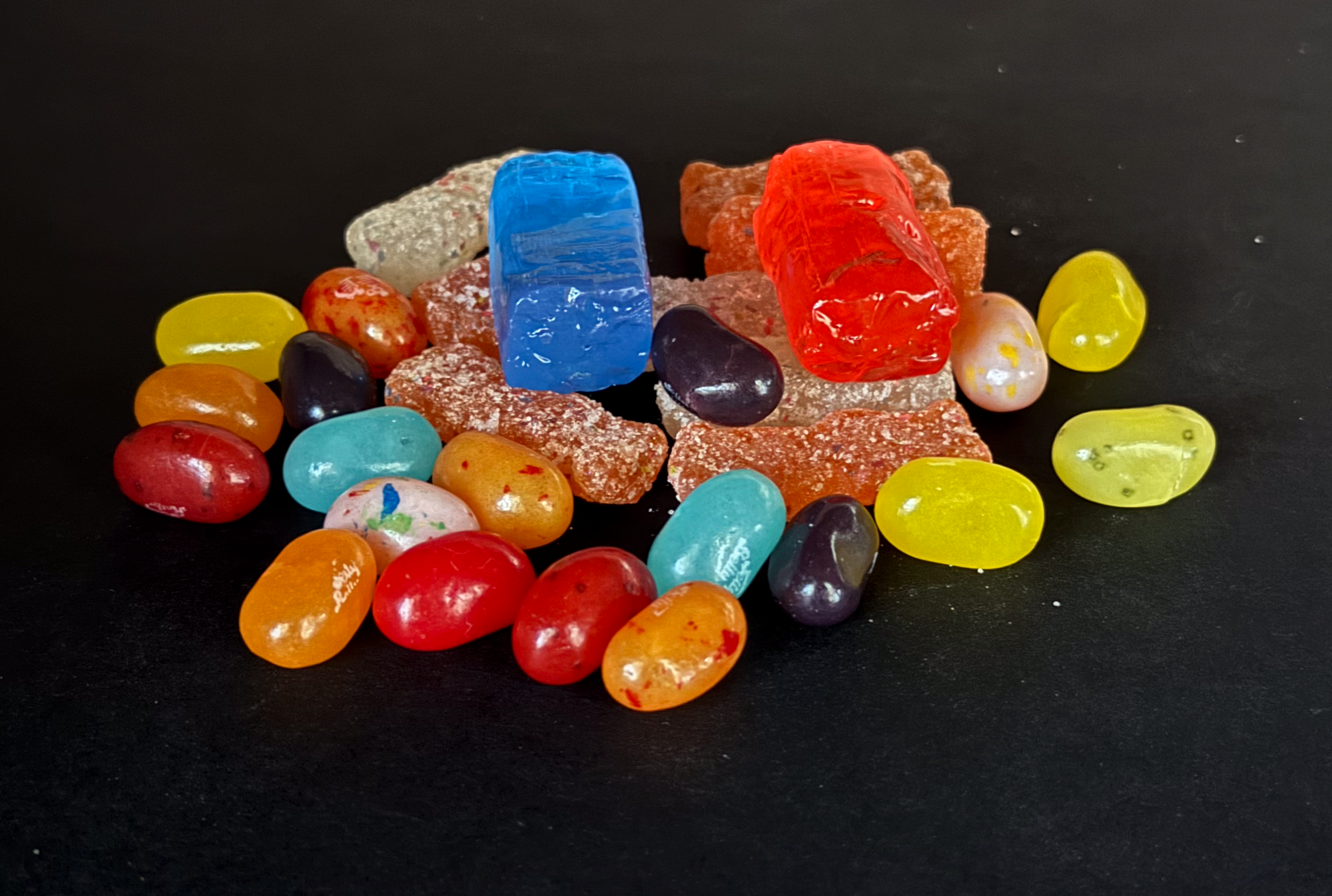 It's a pile of candy. The Sour Patch Kids, with their white sugary/sour coating, are much duller than the other candies.