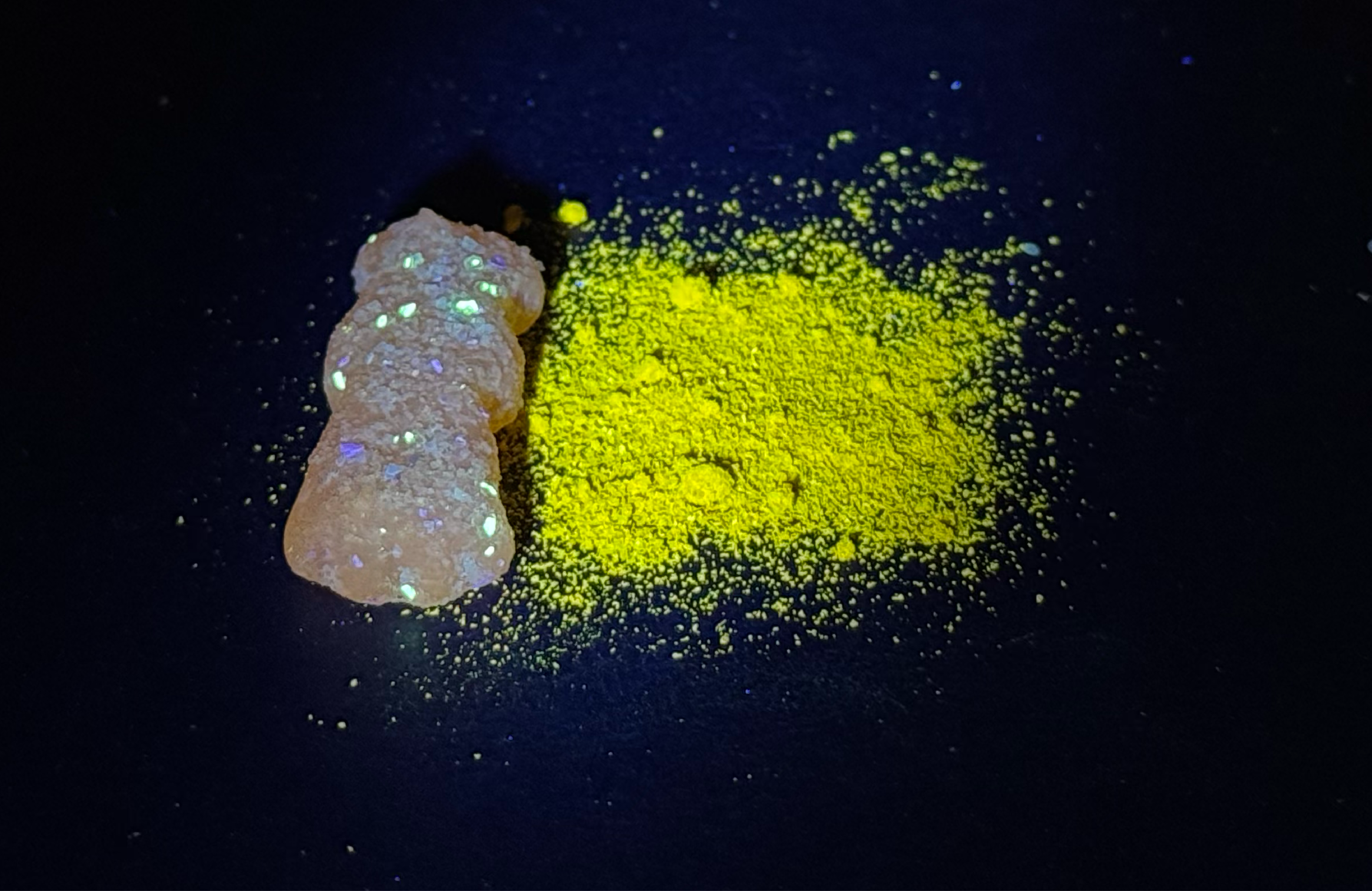 The powdered turmeric glows bright yellow, while the candy sprinkles glow a little greenish.