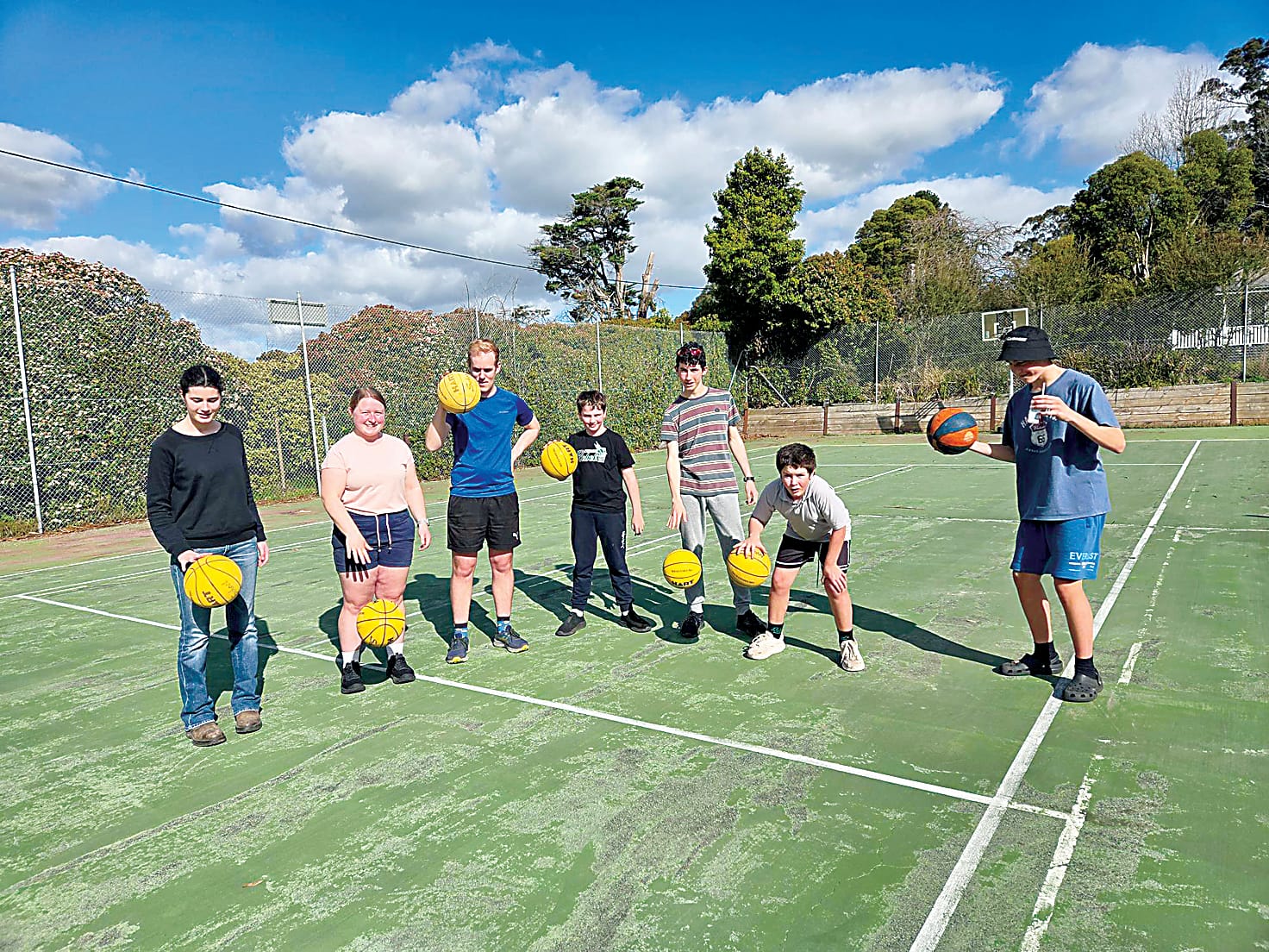 Felicity Waddell (second left) leads the basketball skills activity.