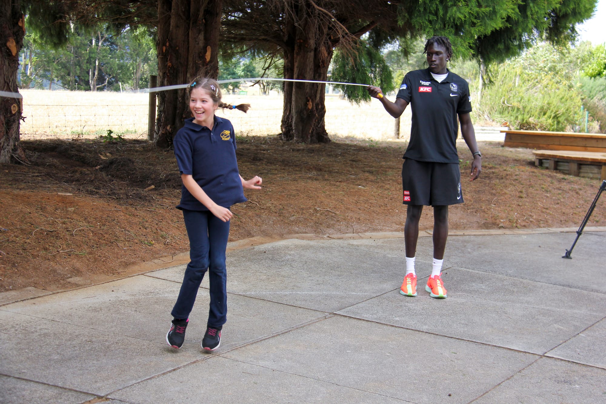 Eden Conroy shows off her jump rope skills to Collingwood's Tew Jiath.