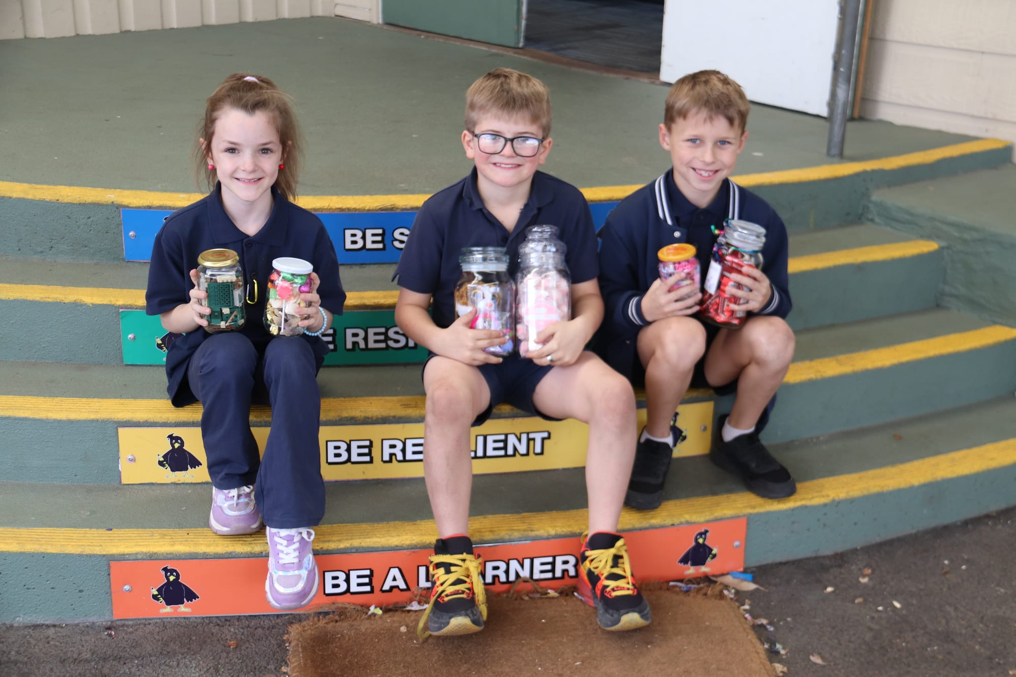 Paige Millard, Zane Carter and Blake Shearn with their lolly jars.