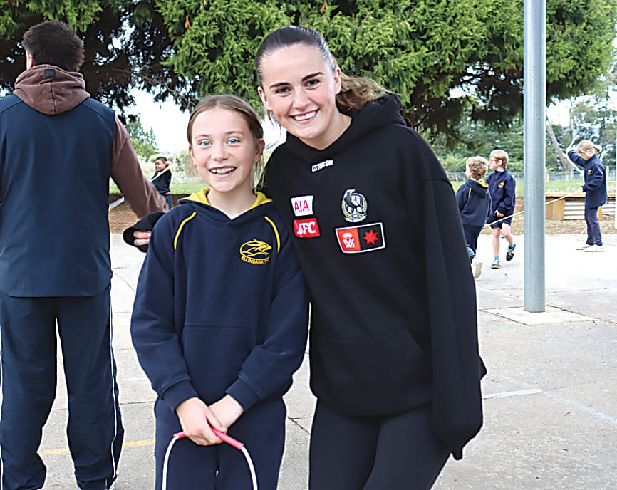 Ellinbank Primary School student Yumi Taylor enjoys showing off her jump rope skills to Collingwood's Kellyann Hogan.