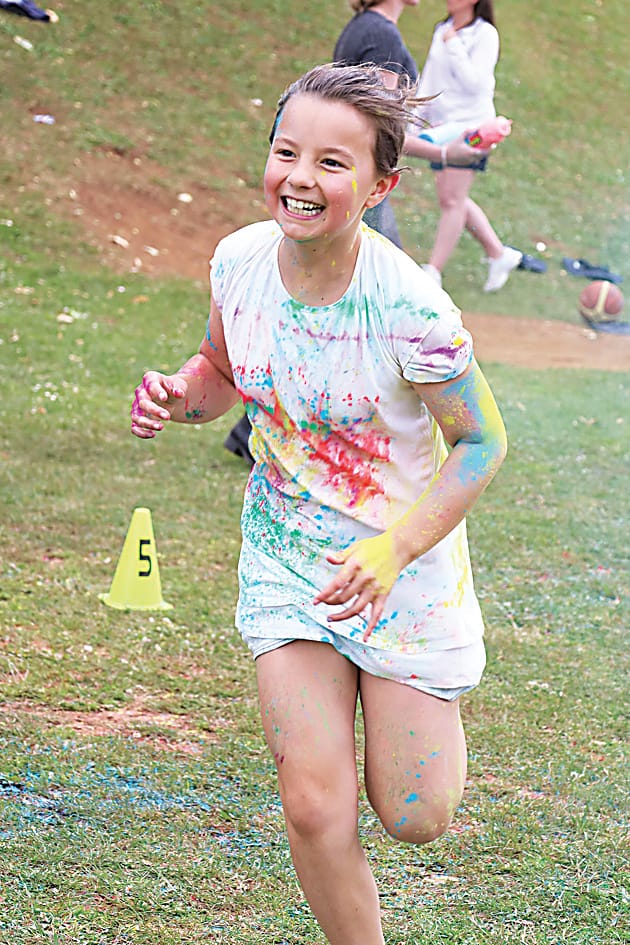 With a big smile, Zoe Kooloos was sure to try and get as much colour dust on her as possible.
