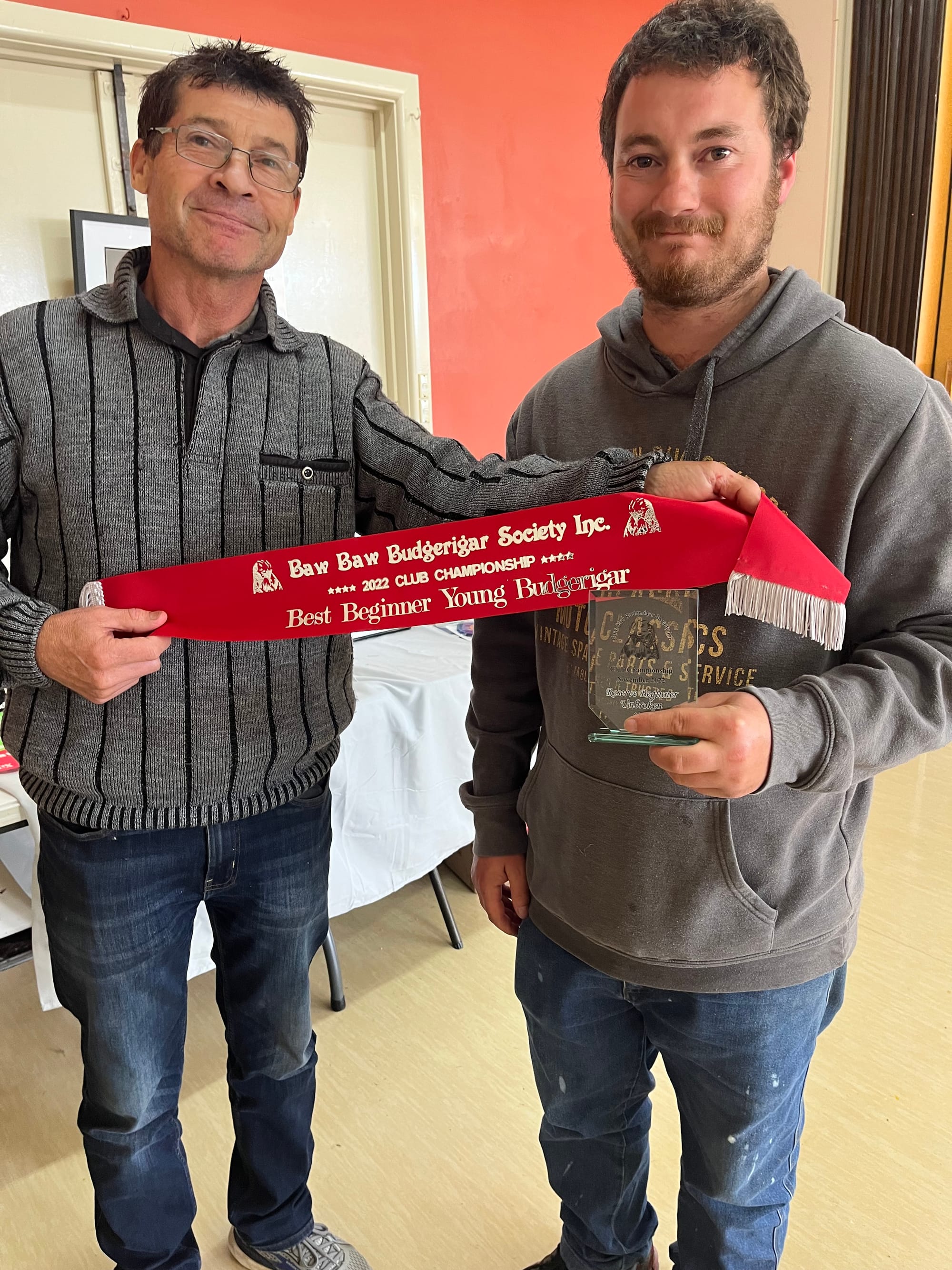 John Rowe with James Mastwyk receiving his sash for best beginner young bird in show.
