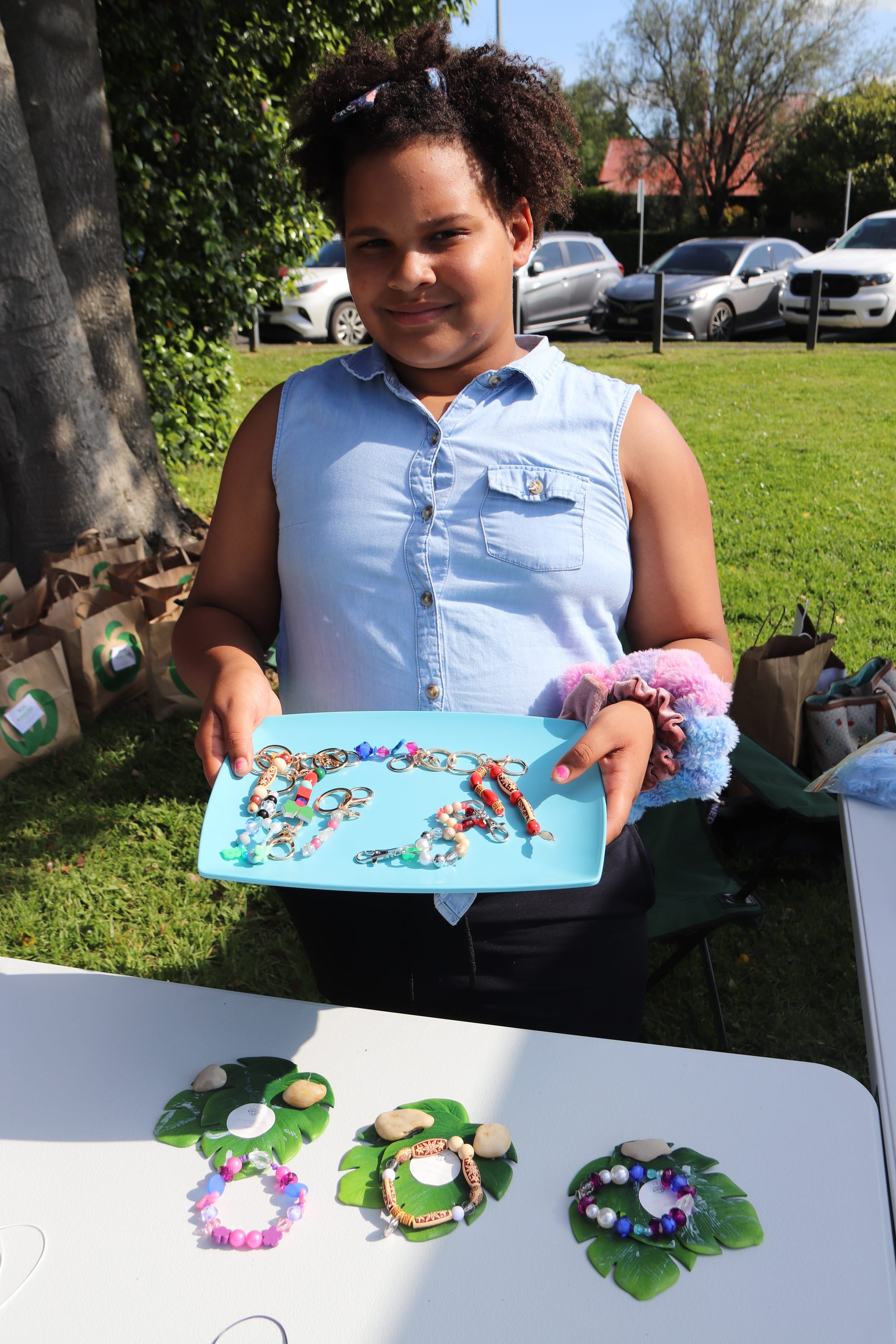 Nine-year-old Addison Stewart shows off the collection of earrings, necklaces, bracelets and keyrings she made for the market.