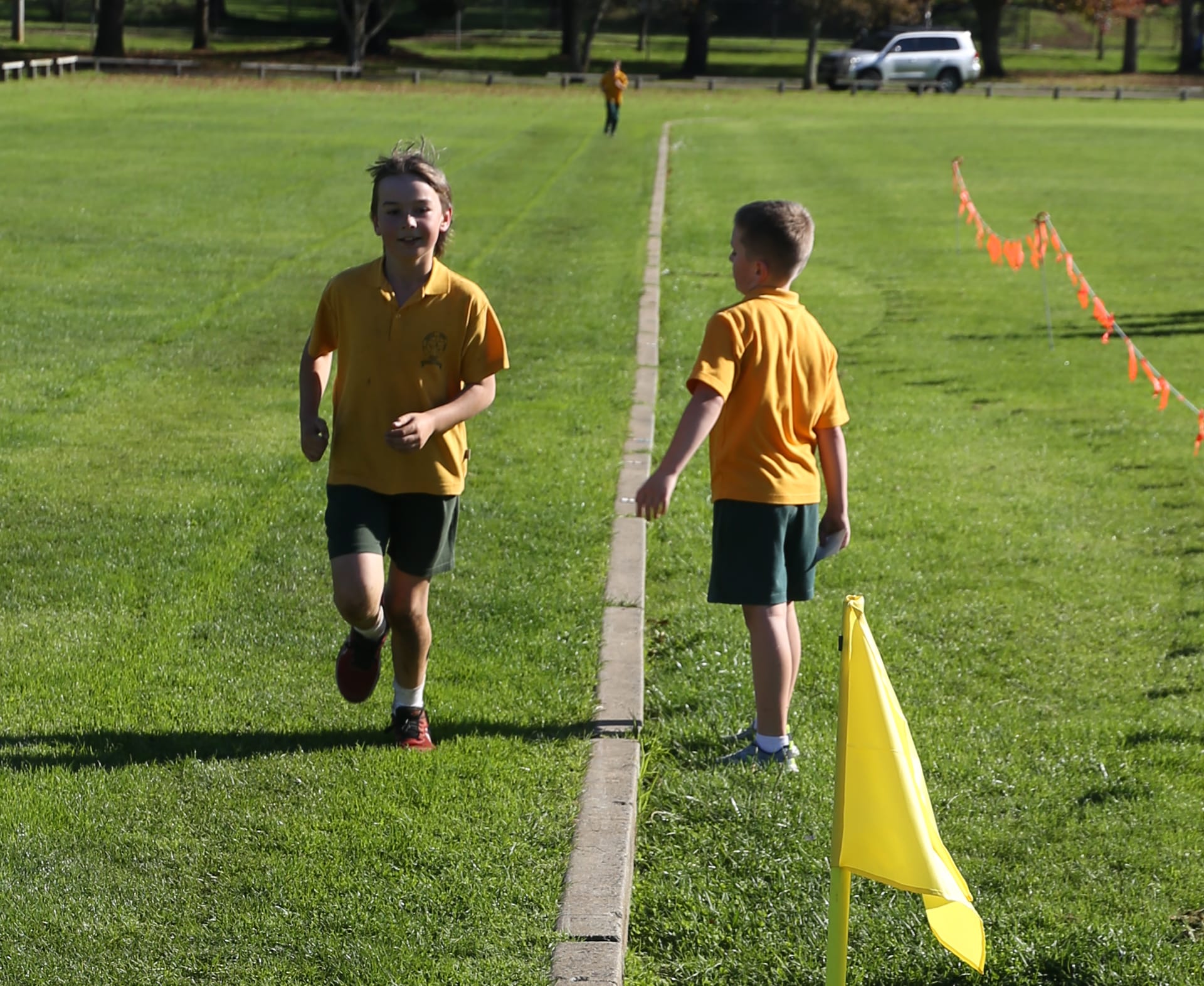 Mark is cheered on by friend Sebastian at the St Joseph's Primary School cross country.