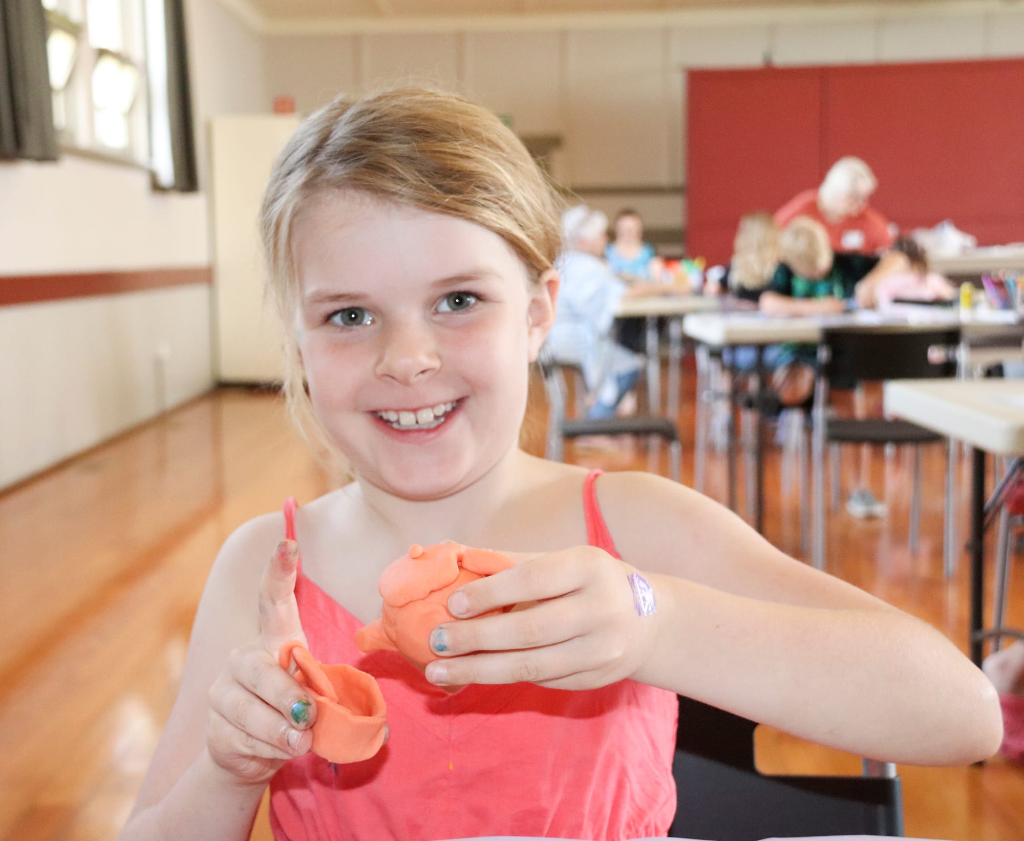 Gracie Gralach pours an imaginary cup of tea  into her handmade clay tea set at Trafalgar on Thursday.