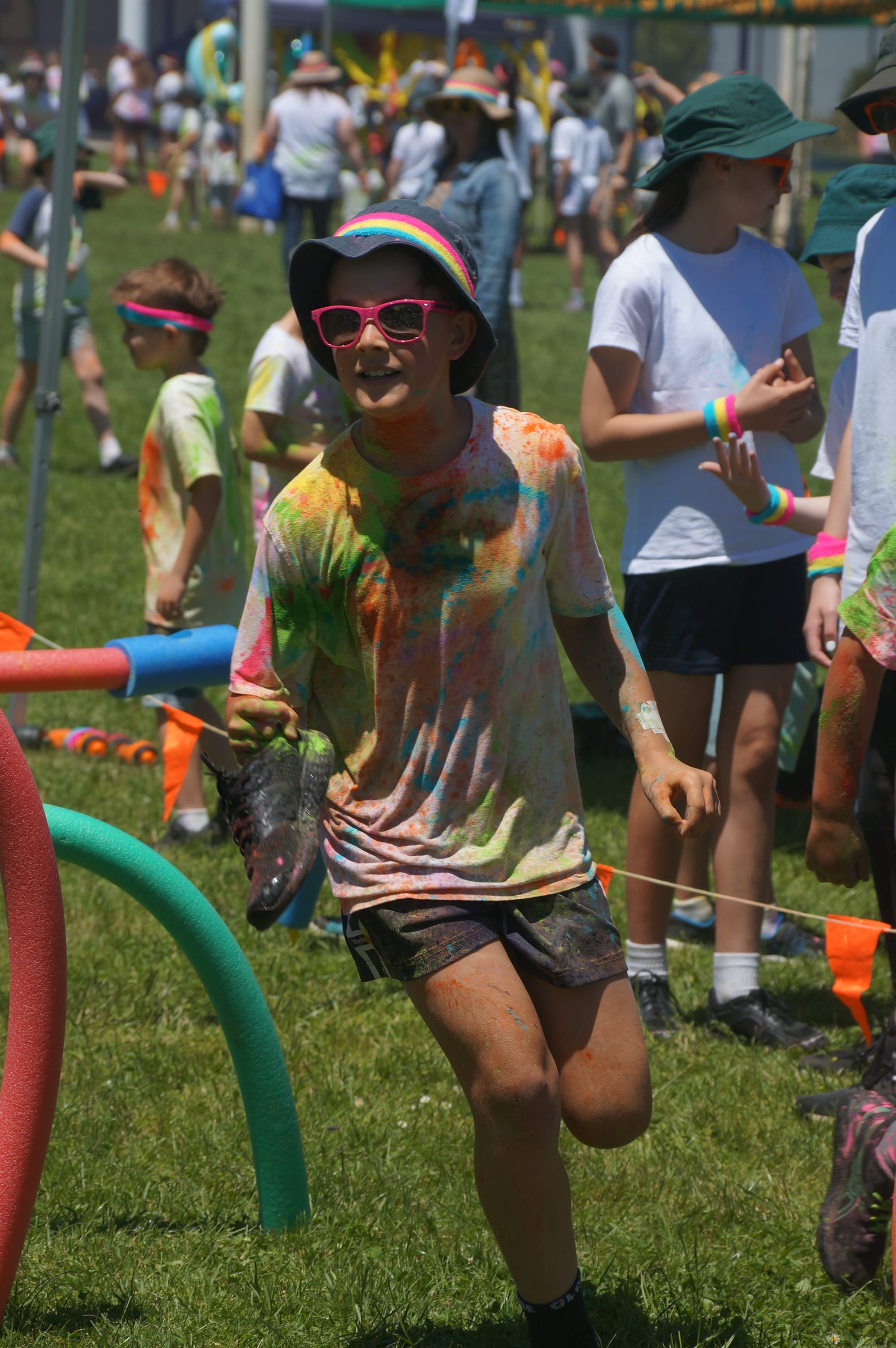 Despite losing a shoe, Coby enjoys the Colour Run at St Josephs, Warragul.