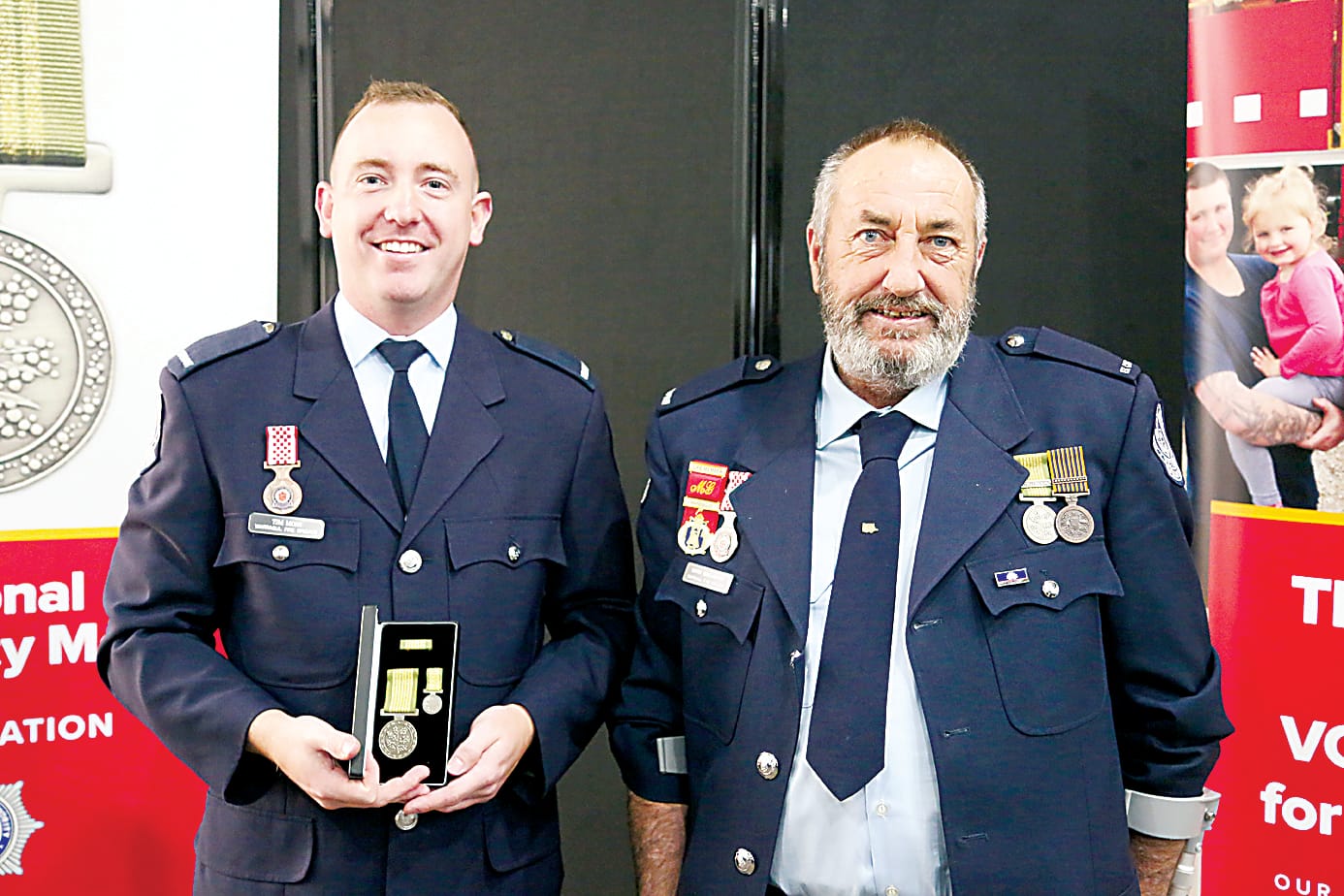 Warragul Fire Brigade members Tim Moss and Mark Gallagher with their National Emergency Medals.